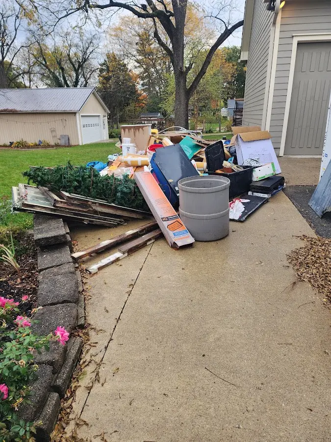 Dumpster being loaded with debris for Estate Cleanout Dumpster Rental in Berea